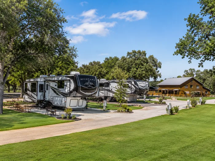 RVs parked on spacious sites beneath the oaks