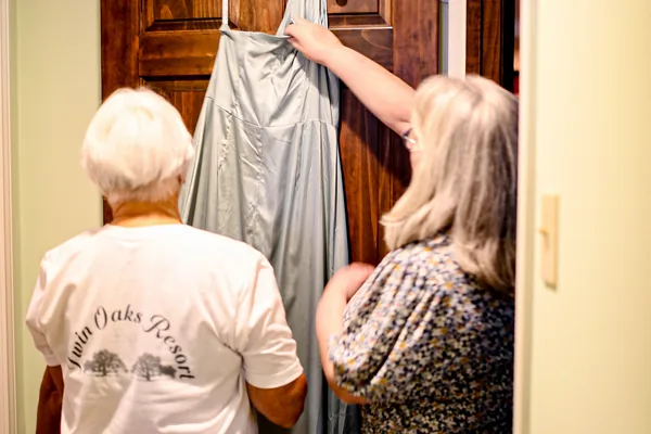 The bride's party getting the dress ready